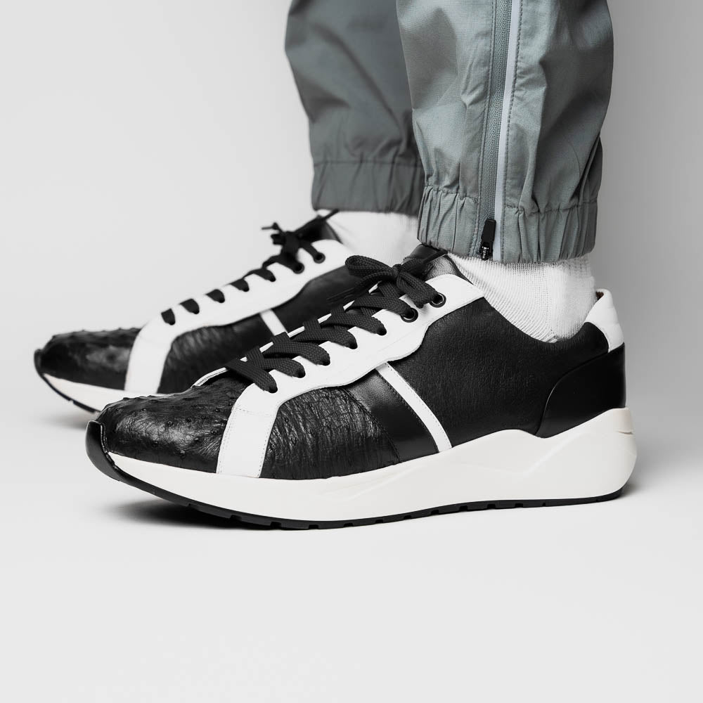The Marco Di Milano Lyon II Black / White sneakers feature textured leather uppers, black laces, and rubber soles, displayed against a plain white background.