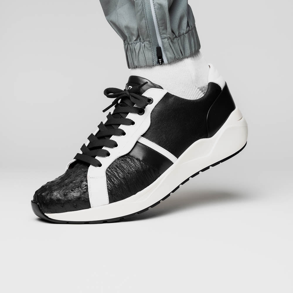 The Marco Di Milano Lyon II Black / White sneakers feature textured leather uppers, black laces, and rubber soles, displayed against a plain white background.