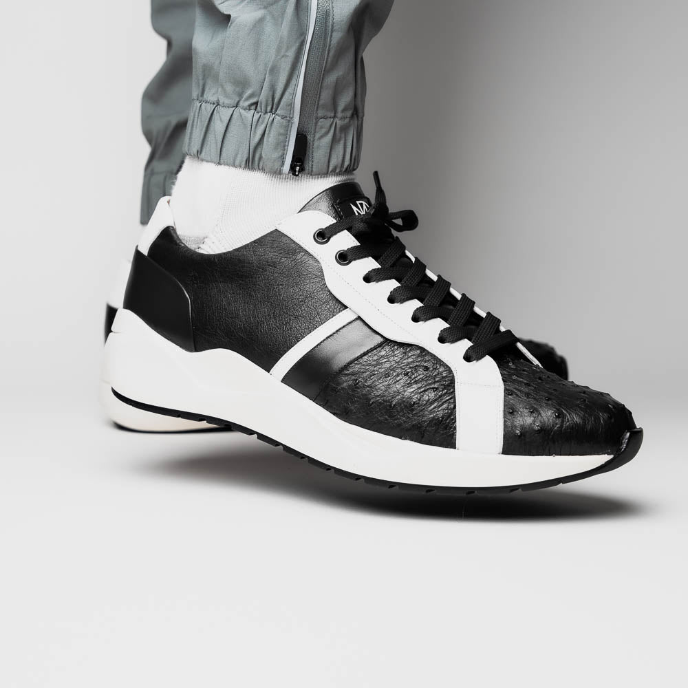 The Marco Di Milano Lyon II Black / White sneakers feature textured leather uppers, black laces, and rubber soles, displayed against a plain white background.