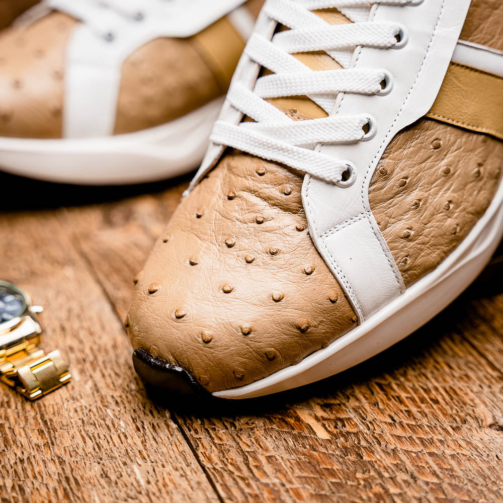 The Marco Di Milano Lyon II Orix / White sneakers feature beige and white ostrich quill-textured uppers and black rubber soles—an ideal choice for those seeking luxury footwear.