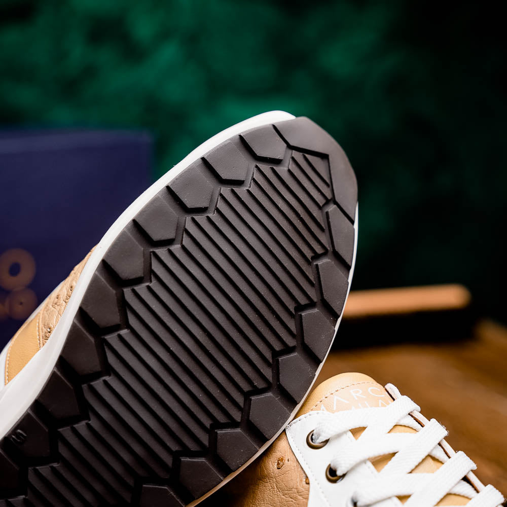 The Marco Di Milano Lyon II Orix / White sneakers feature beige and white ostrich quill-textured uppers and black rubber soles—an ideal choice for those seeking luxury footwear.