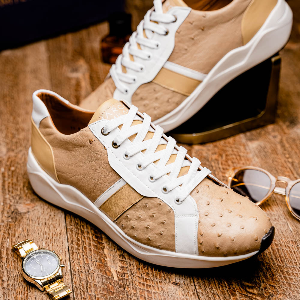 The Marco Di Milano Lyon II Orix / White sneakers feature beige and white ostrich quill-textured uppers and black rubber soles—an ideal choice for those seeking luxury footwear.
