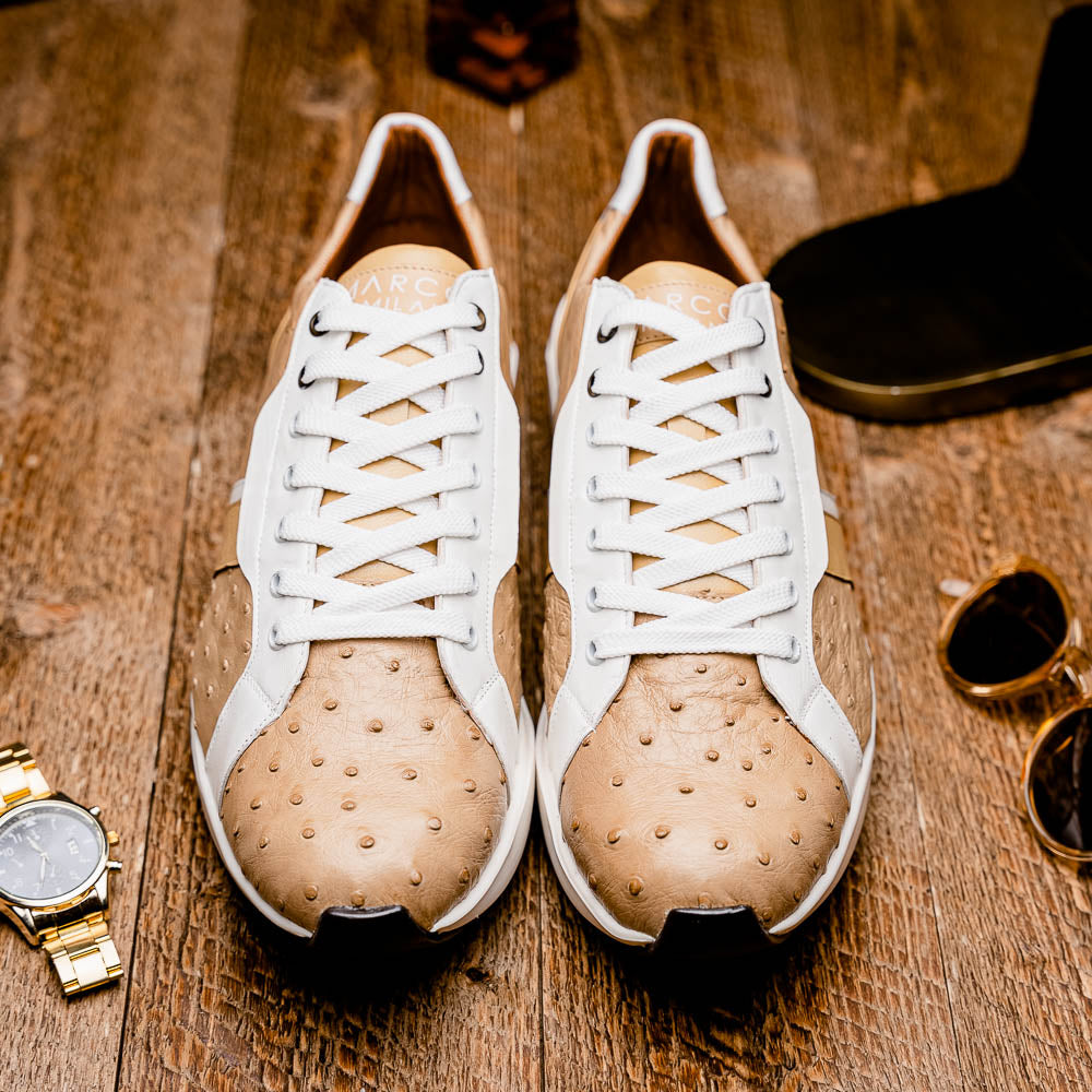 The Marco Di Milano Lyon II Orix / White sneakers feature beige and white ostrich quill-textured uppers and black rubber soles—an ideal choice for those seeking luxury footwear.