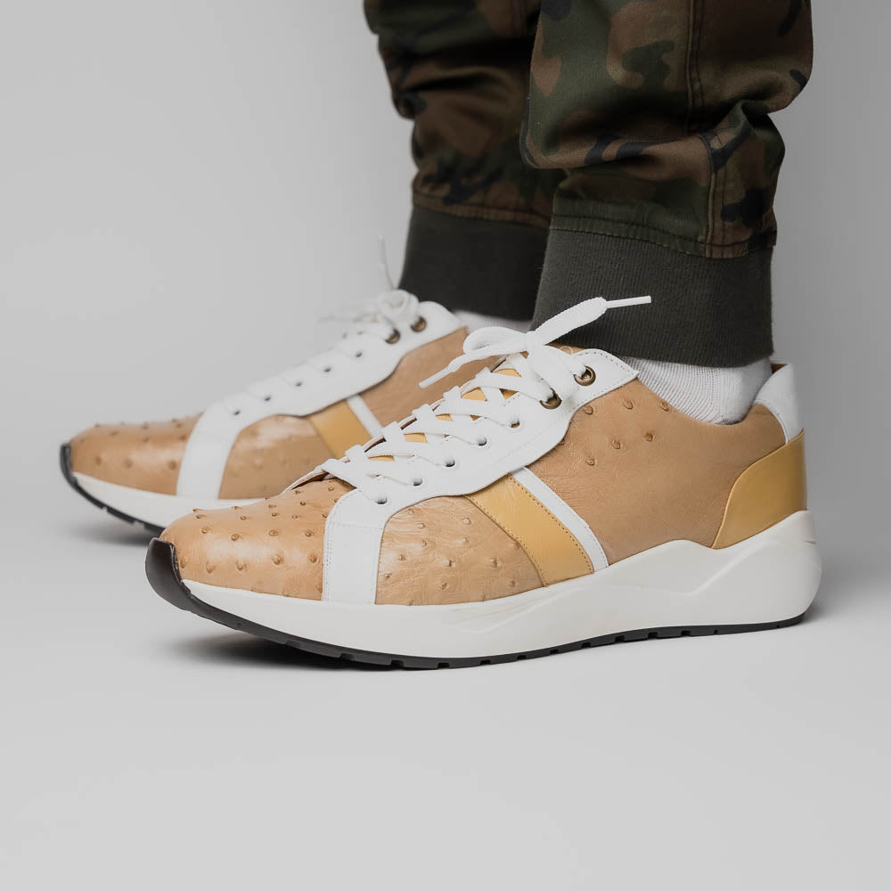 The Marco Di Milano Lyon II Orix / White sneakers feature beige and white ostrich quill-textured uppers and black rubber soles—an ideal choice for those seeking luxury footwear.