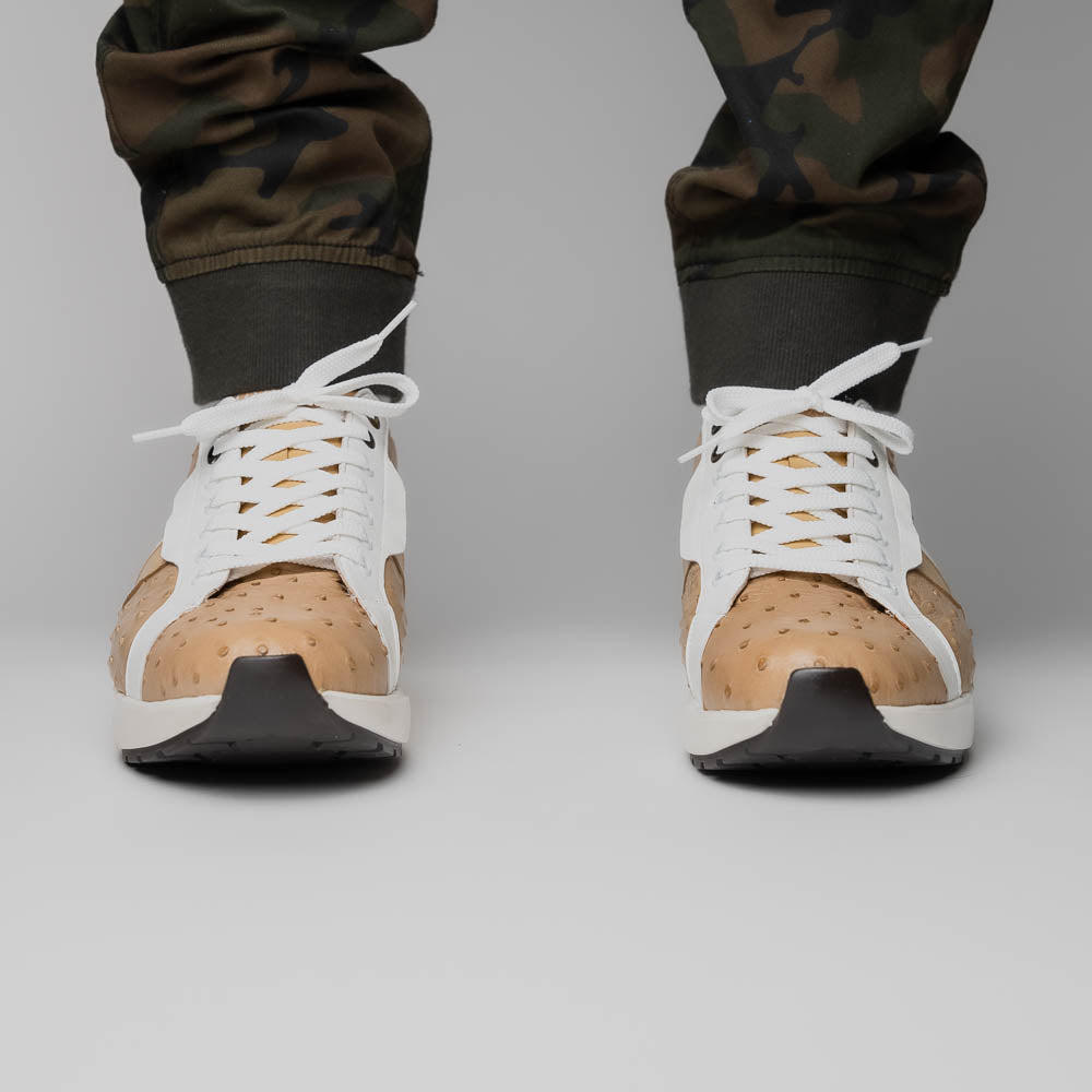 The Marco Di Milano Lyon II Orix / White sneakers feature beige and white ostrich quill-textured uppers and black rubber soles—an ideal choice for those seeking luxury footwear.
