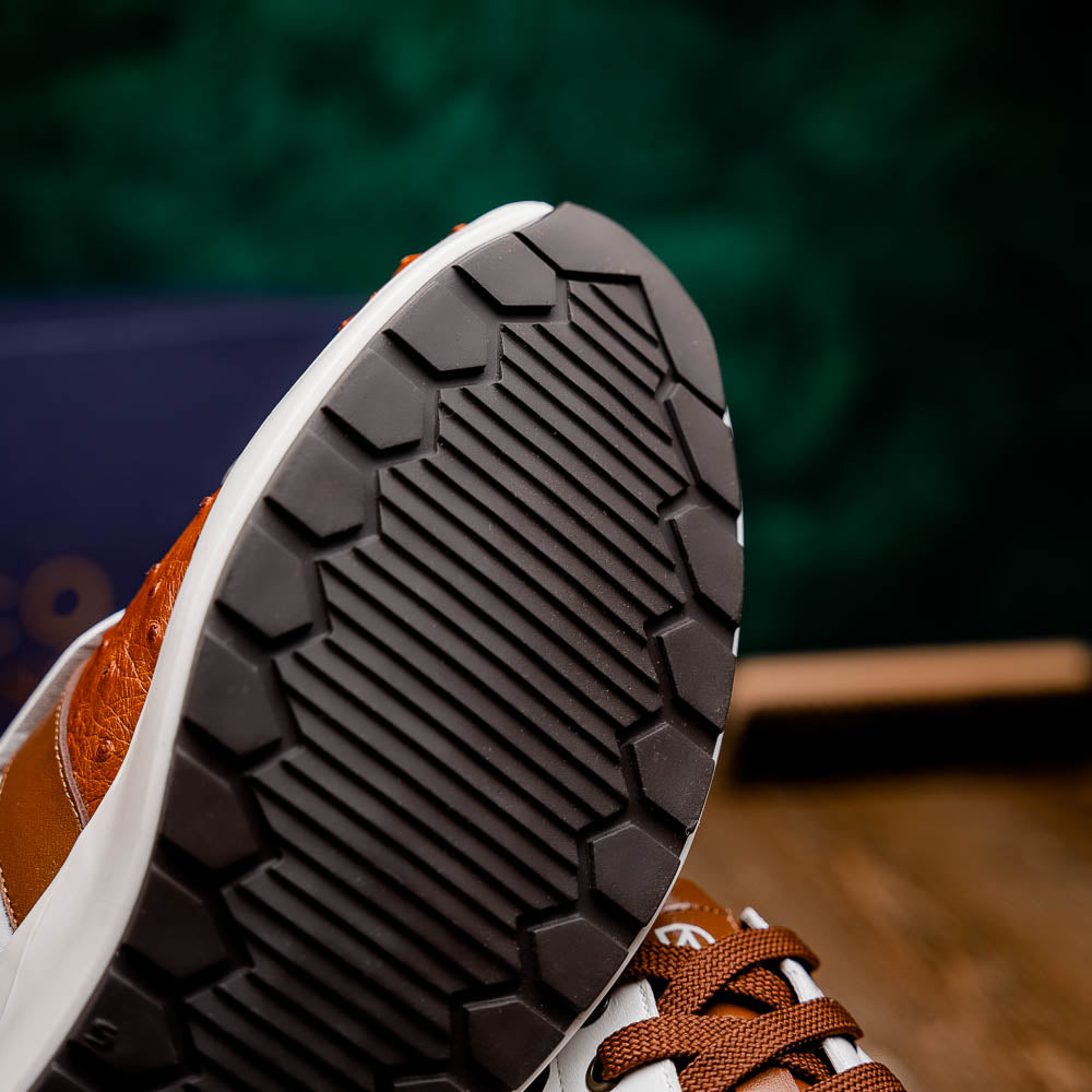 The Lyon II Brandy / White sneakers by Marco Di Milano feature a textured brown and white leather upper, white soles, and brown laces—a true statement in luxury footwear, shown against a plain white background.
