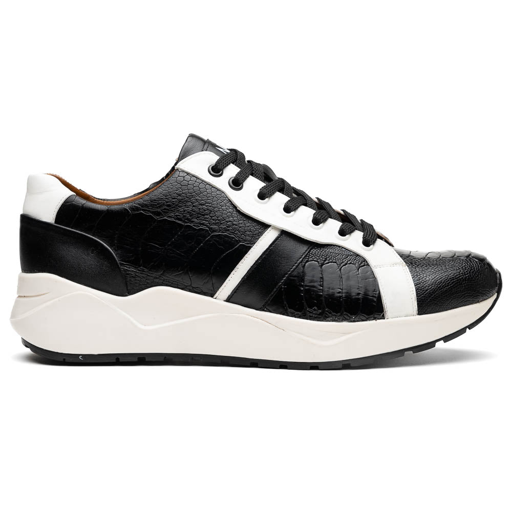 The Marco Di Milano Lyon Black / White sneakers feature a hand-painted, textured pattern, black laces, and rubber soles—one shoe shown upright, the other propped behind.
