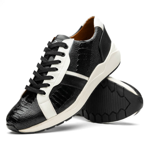 The Marco Di Milano Lyon Black / White sneakers feature a hand-painted, textured pattern, black laces, and rubber soles—one shoe shown upright, the other propped behind.