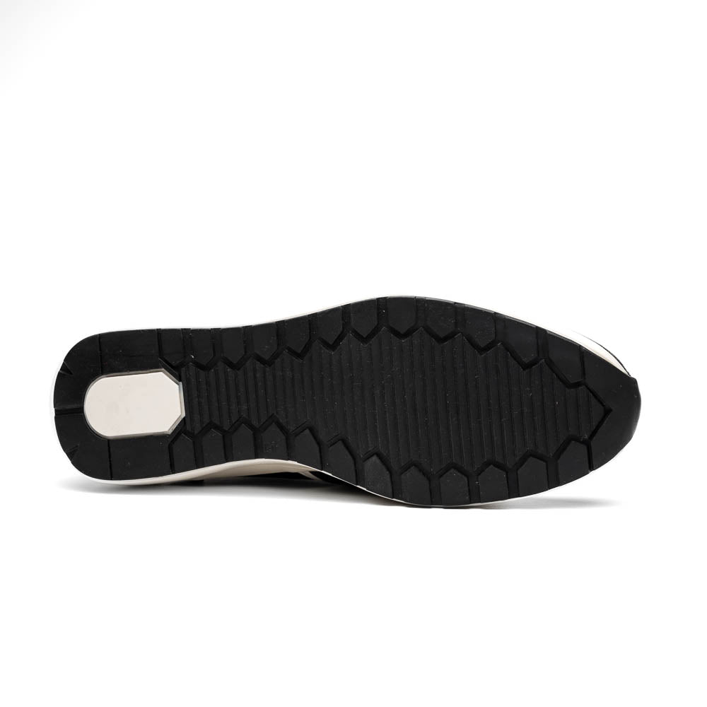 The Marco Di Milano Lyon Black / White sneakers feature a hand-painted, textured pattern, black laces, and rubber soles—one shoe shown upright, the other propped behind.