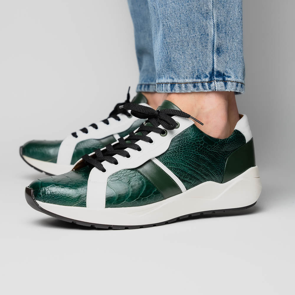 The Marco Di Milano Lyon Green / White sneakers feature green and white genuine ostrich leather with texture, black laces, and white rubber soles—one shoe stands upright while the other leans against it.