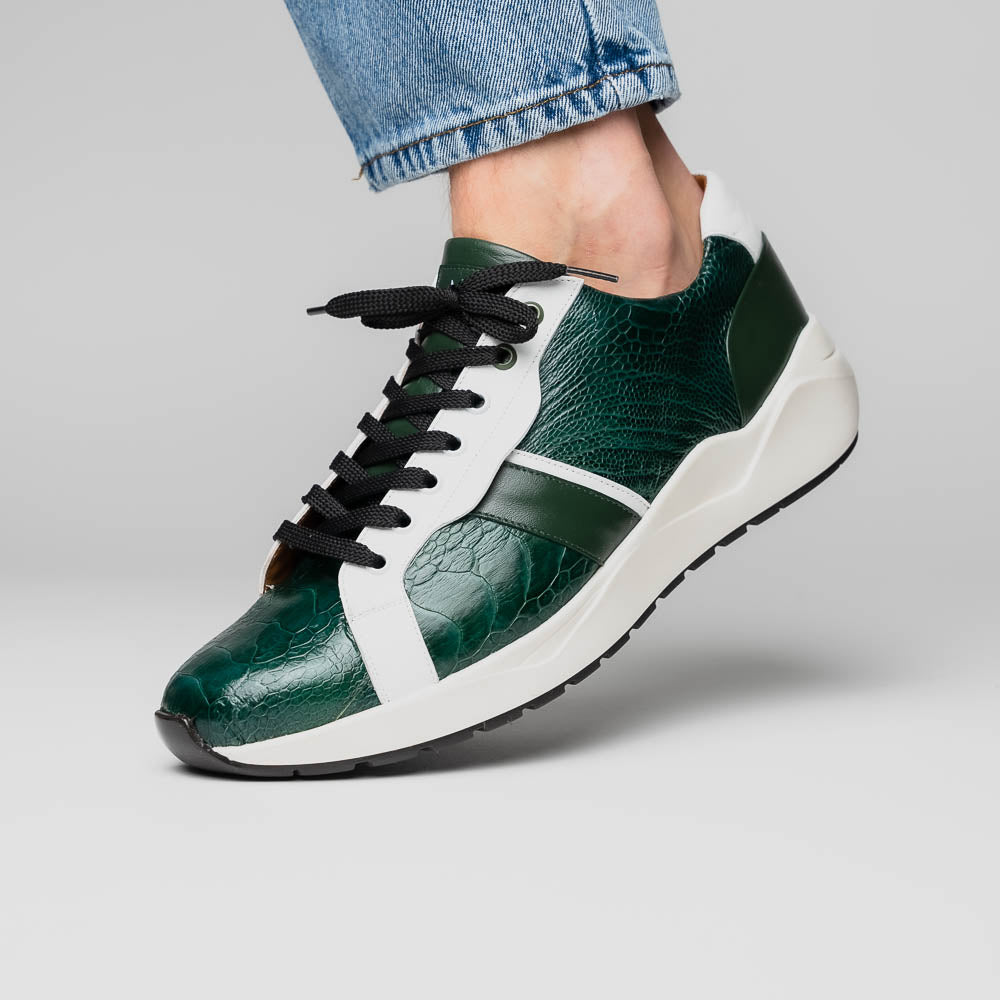 The Marco Di Milano Lyon Green / White sneakers feature green and white genuine ostrich leather with texture, black laces, and white rubber soles—one shoe stands upright while the other leans against it.