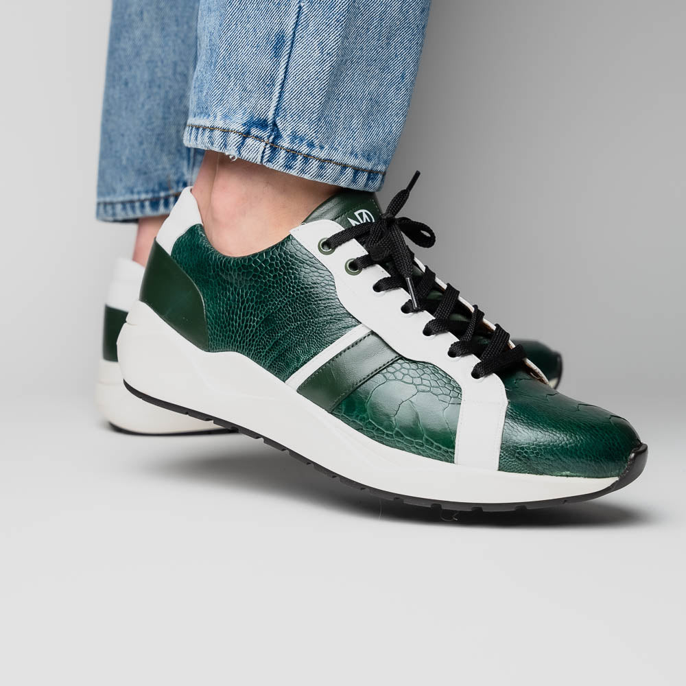 The Marco Di Milano Lyon Green / White sneakers feature green and white genuine ostrich leather with texture, black laces, and white rubber soles—one shoe stands upright while the other leans against it.