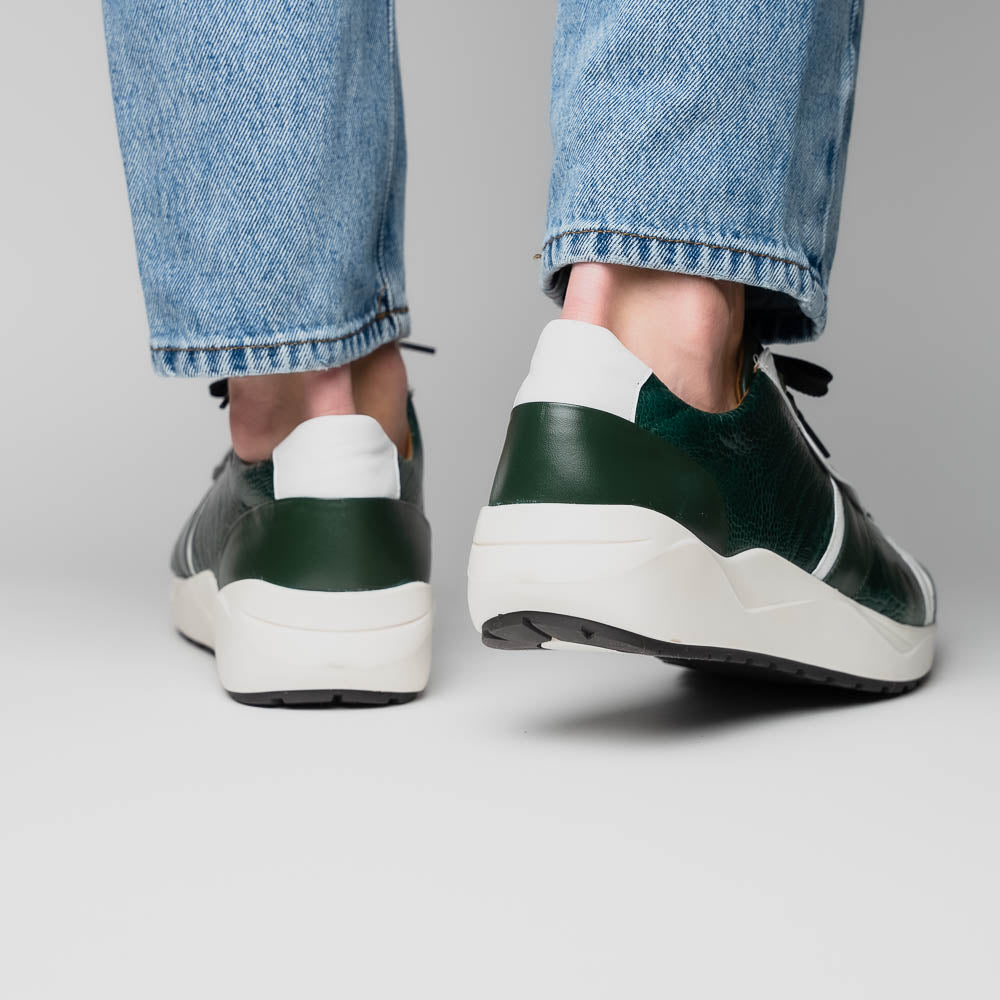 The Marco Di Milano Lyon Green / White sneakers feature green and white genuine ostrich leather with texture, black laces, and white rubber soles—one shoe stands upright while the other leans against it.