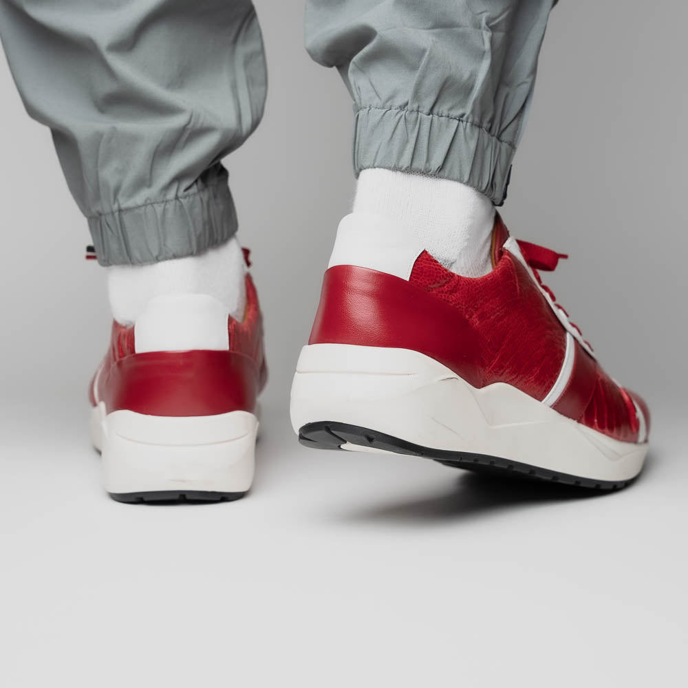 The Marco Di Milano Lyon Red / White are luxury low-top sneakers featuring a hand-painted finish, textured leather, white soles, red laces, and black tread, showcased on a plain white background.
