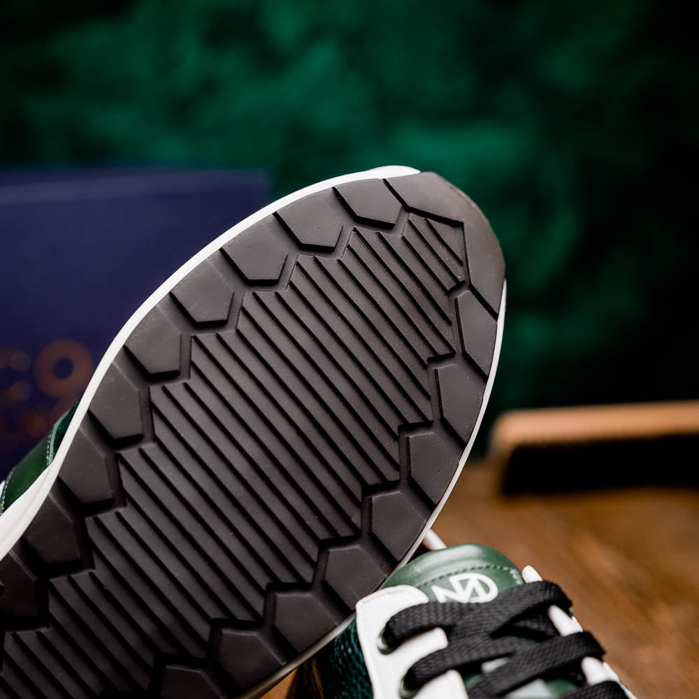 The Marco Di Milano Lyon Green / White sneakers feature green and white genuine ostrich leather with texture, black laces, and white rubber soles—one shoe stands upright while the other leans against it.