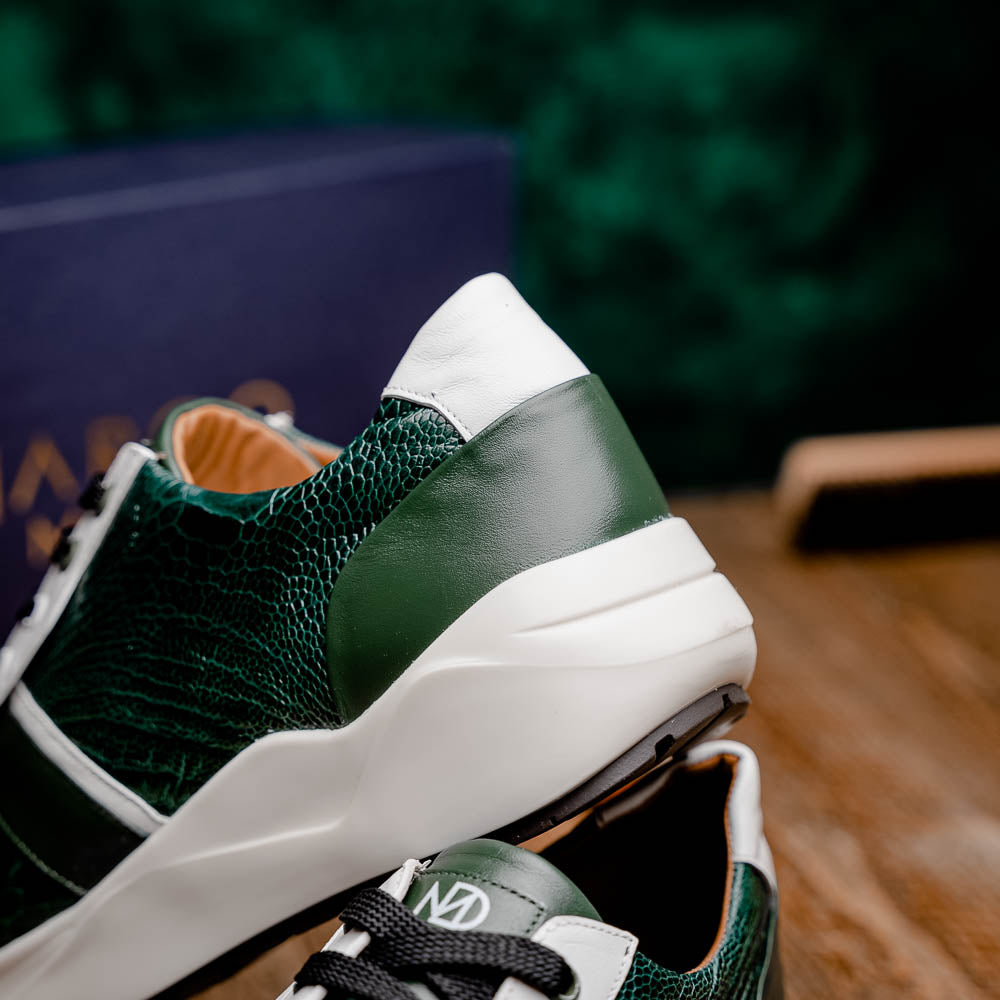 The Marco Di Milano Lyon Green / White sneakers feature green and white genuine ostrich leather with texture, black laces, and white rubber soles—one shoe stands upright while the other leans against it.