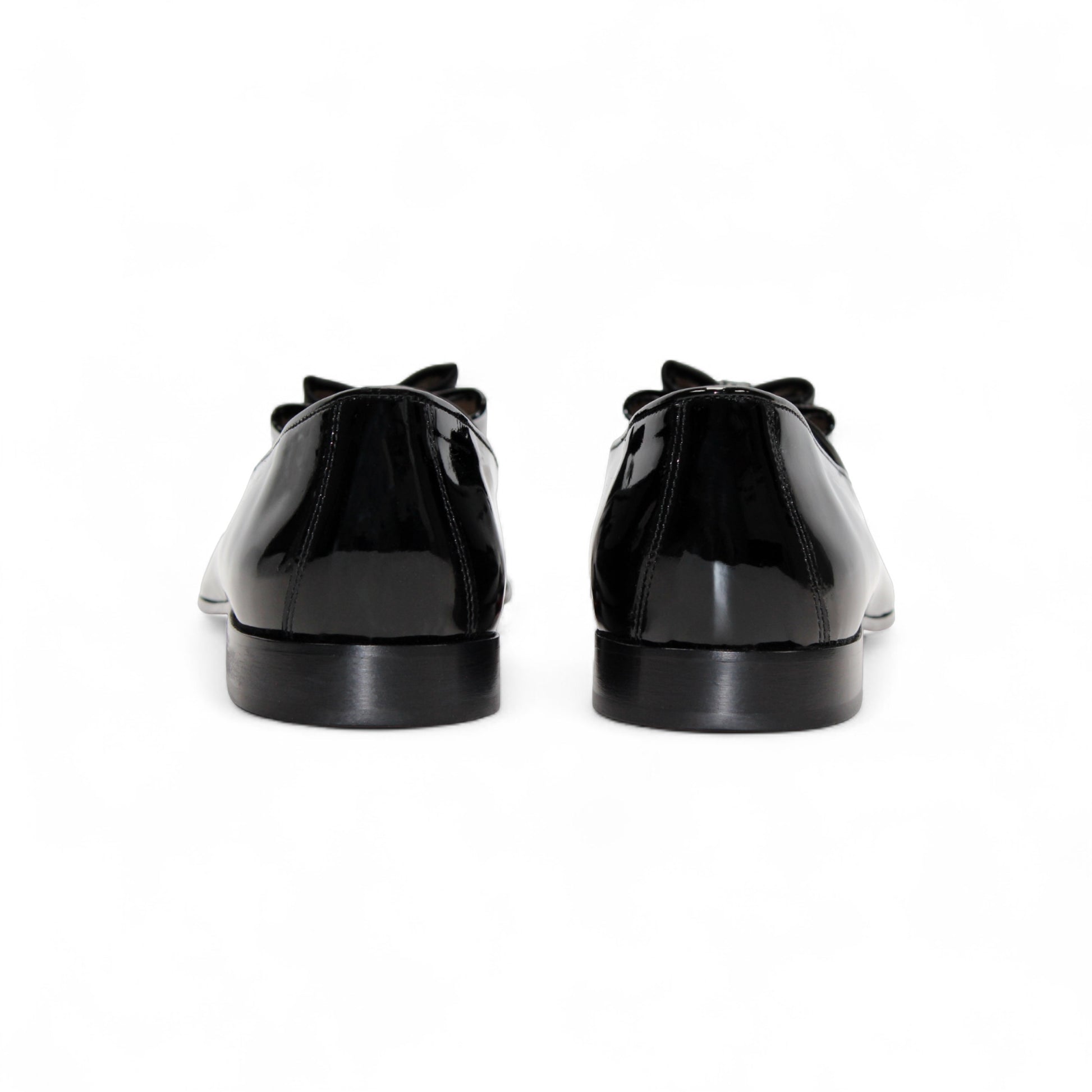 The Duca Maratea Black by Duca Di Matiste is a black patent leather loafer with a low heel, suede strap, and metal studs, highlighting fine Italian craftsmanship against a white background.
