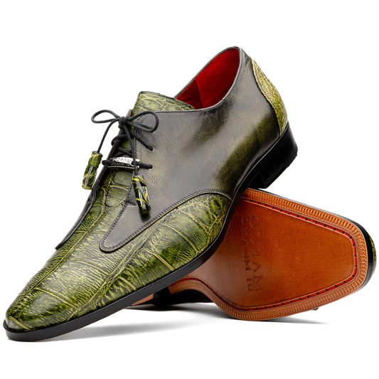 A pair of Anzio Rustic Green men's dress shoes by Marco Di Milano, featuring a green textured finish, black laces, and brown leather soles—one upright and one lying on its side.