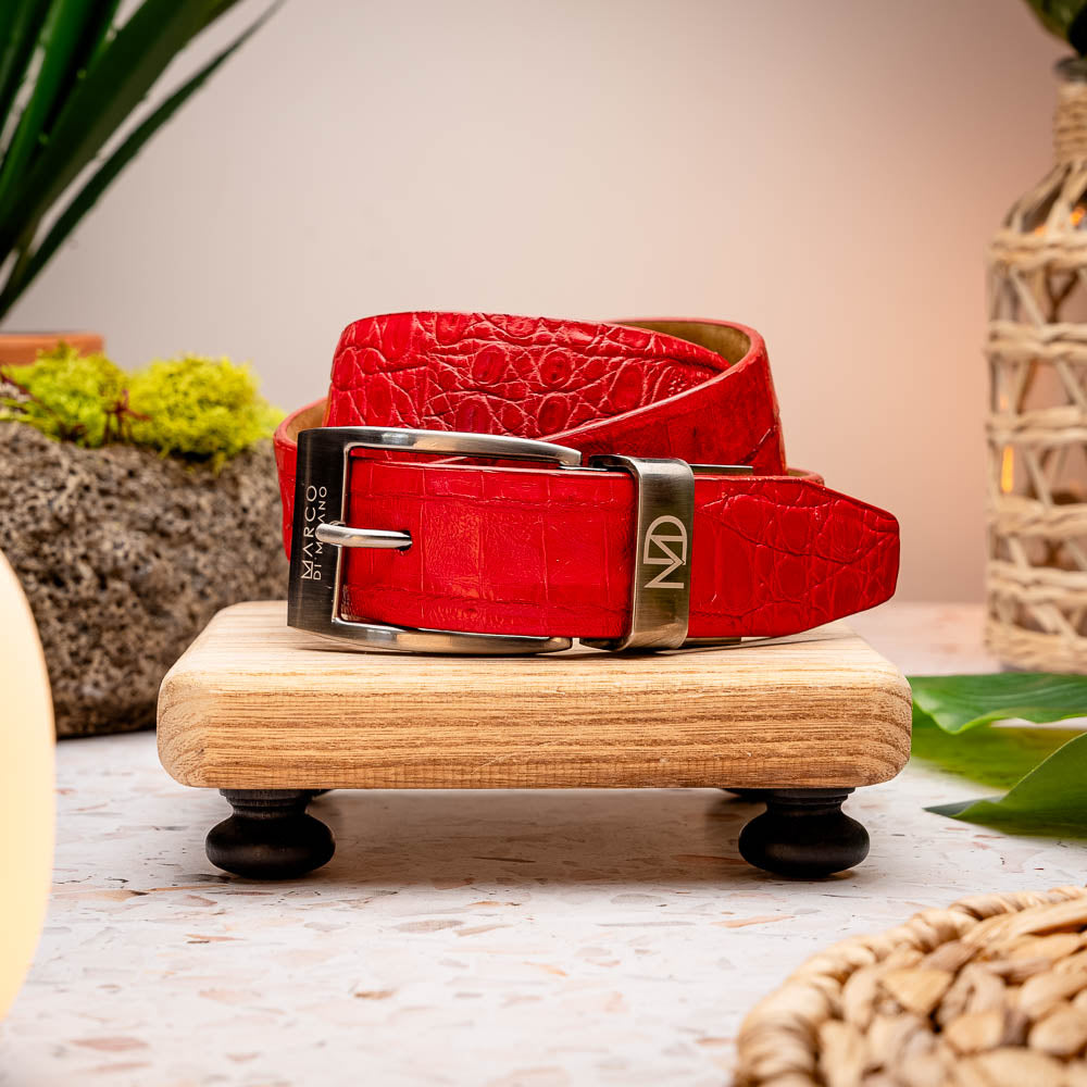 The Riccardo Belt Light Red by Marco Di Milano features crocodile-embossed exotic leather and a silver buckle engraved with the brand’s logo.