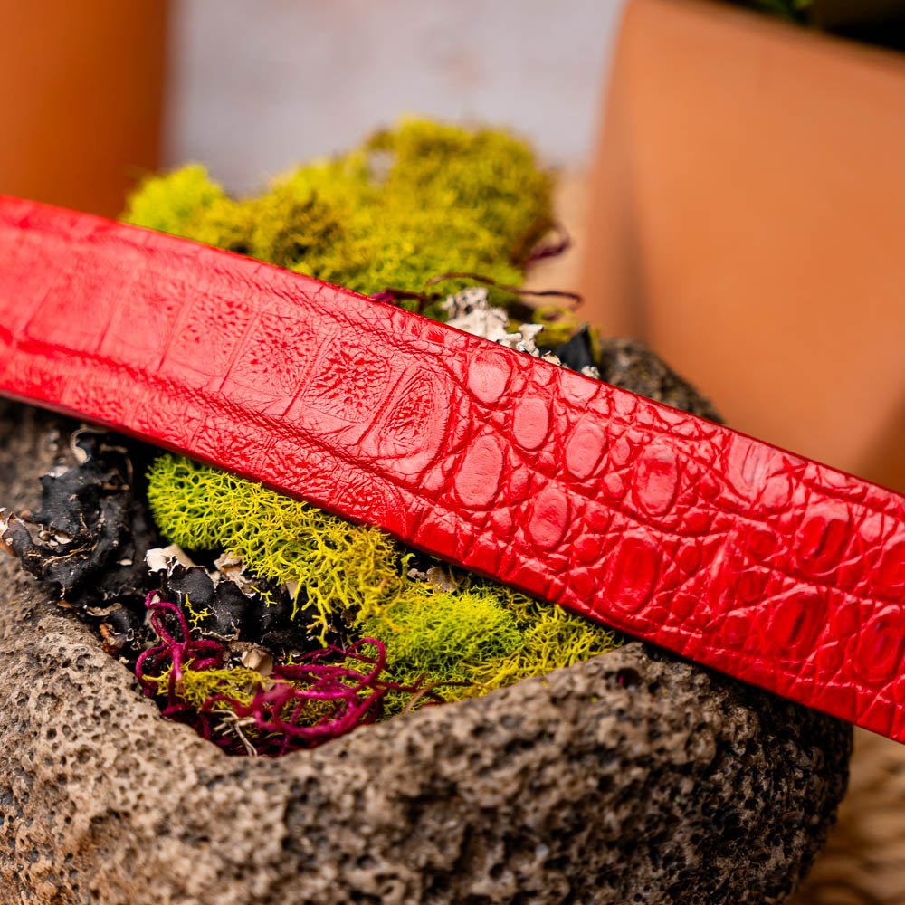 The Riccardo Belt Light Red by Marco Di Milano features crocodile-embossed exotic leather and a silver buckle engraved with the brand’s logo.