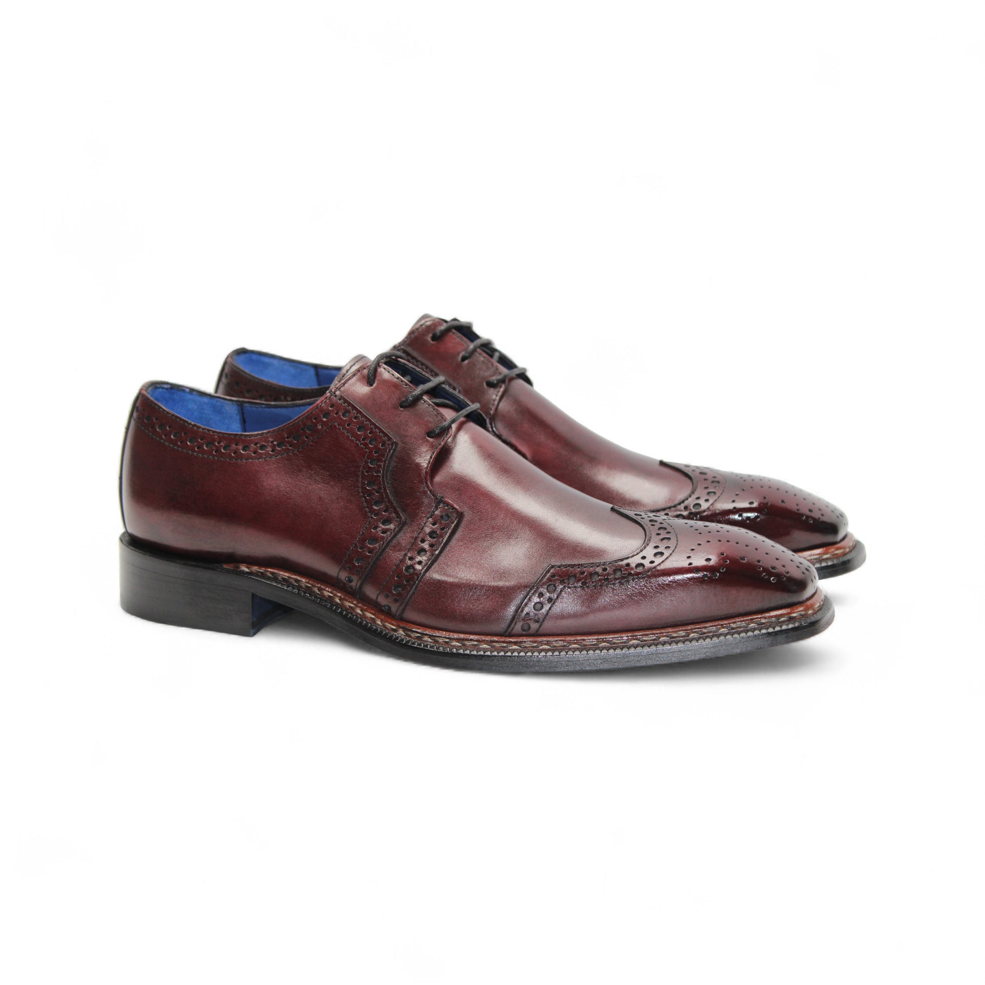 The Emilio Franco Marco Burgundy by Emilio Franco is a genuine leather oxford dress shoe with brogue detailing, closed lacing, and a low black heel, shown in profile on white—an elegant choice among timeless men's footwear.