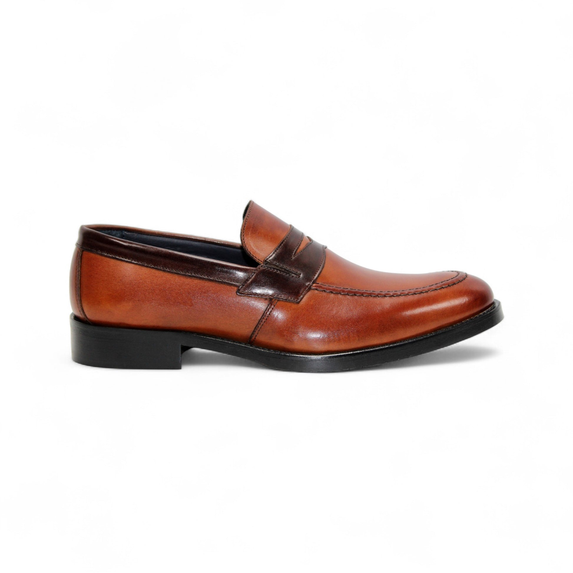 The Firmani Mark Cognac/Brown by Firmani is a men's loafer in genuine brown leather with darker trim, low heel, and moccasin stitching—an elegant dress shoe shown in side profile against a white background.
