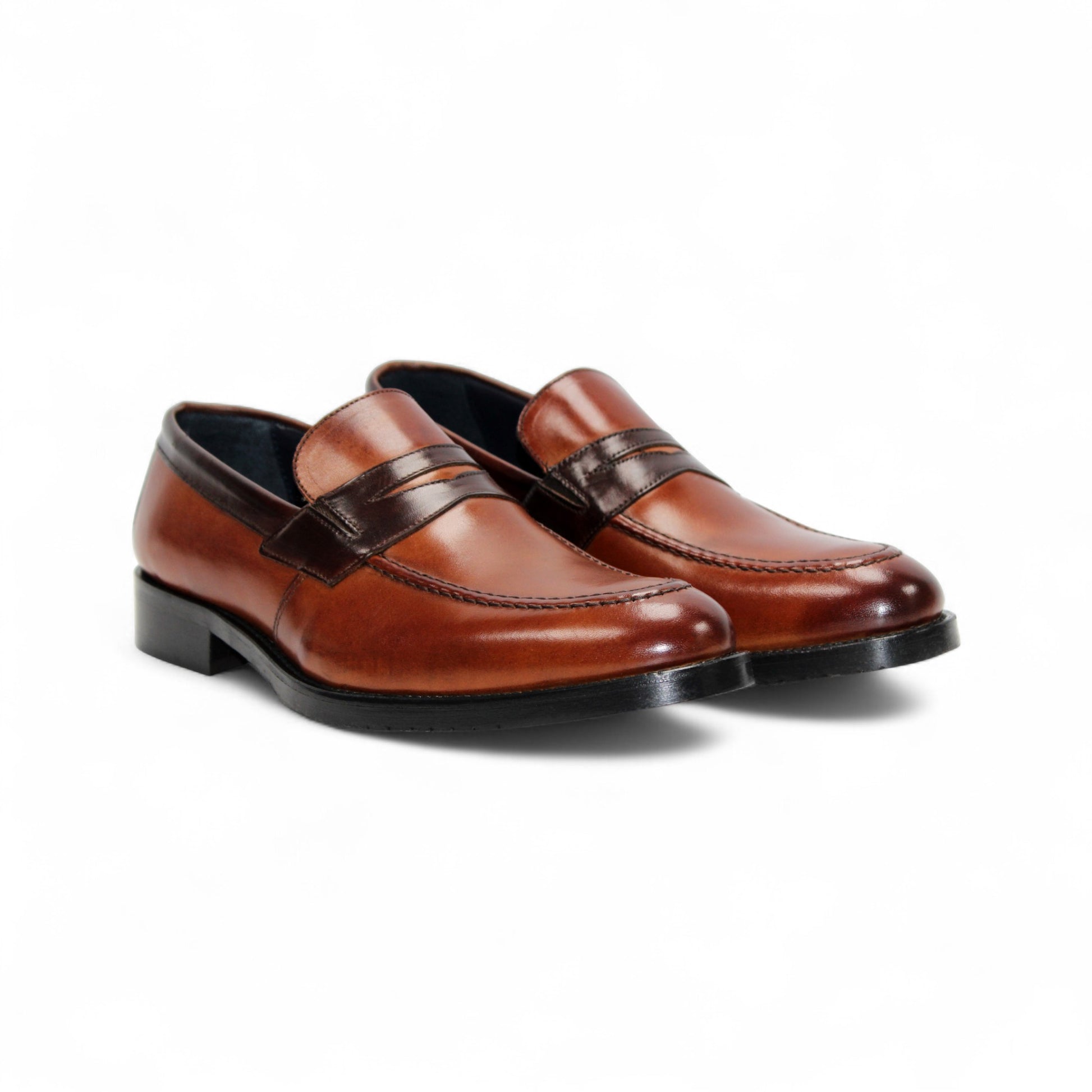 The Firmani Mark Cognac/Brown by Firmani is a men's loafer in genuine brown leather with darker trim, low heel, and moccasin stitching—an elegant dress shoe shown in side profile against a white background.
