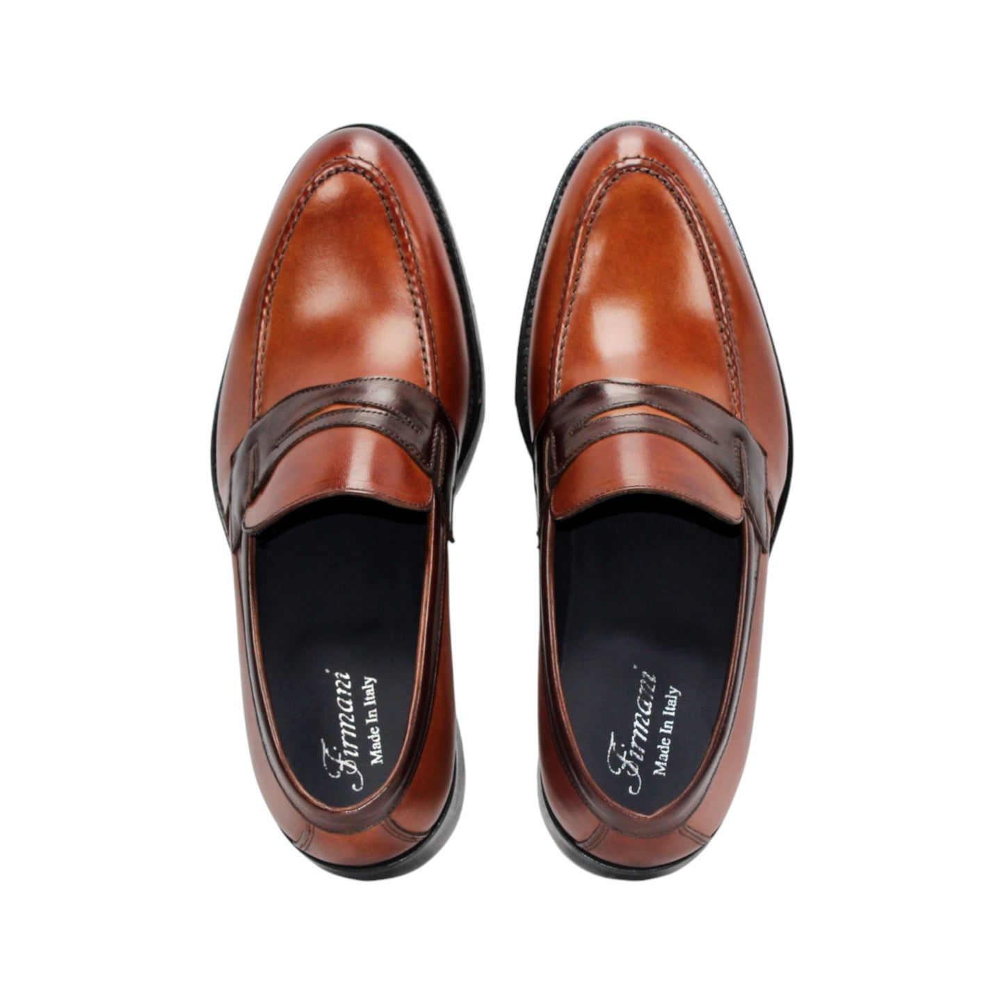 The Firmani Mark Cognac/Brown by Firmani is a men's loafer in genuine brown leather with darker trim, low heel, and moccasin stitching—an elegant dress shoe shown in side profile against a white background.