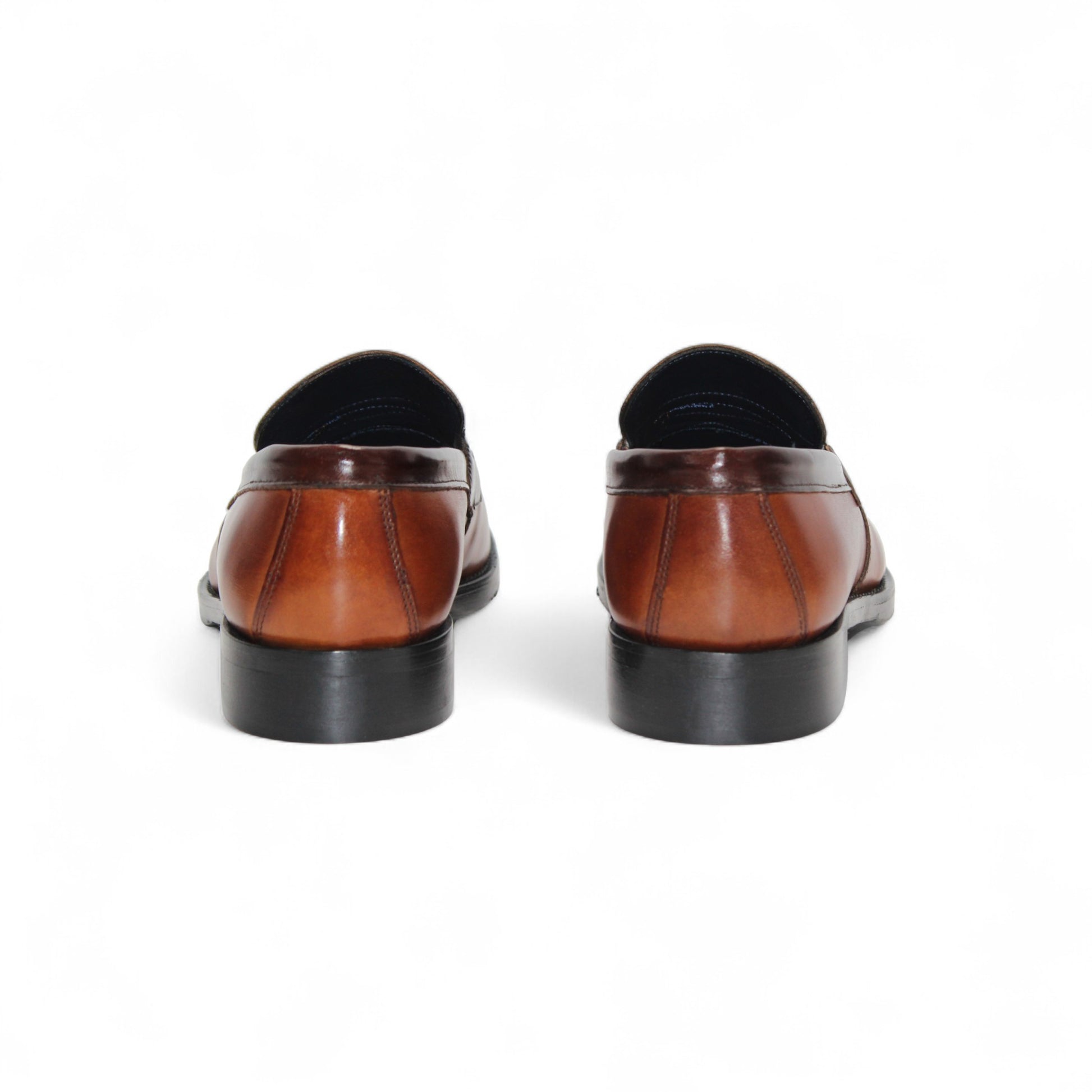 The Firmani Mark Cognac/Brown by Firmani is a men's loafer in genuine brown leather with darker trim, low heel, and moccasin stitching—an elegant dress shoe shown in side profile against a white background.