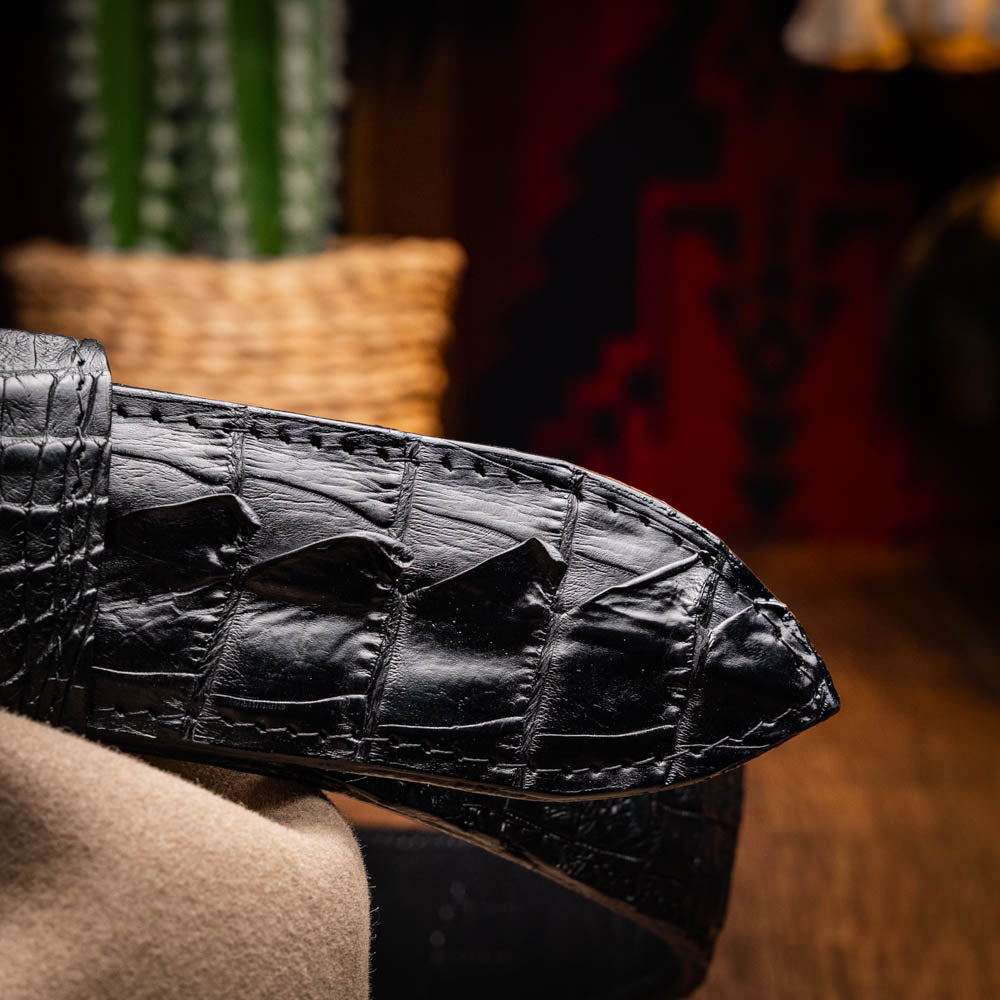 The Marlboro Belt Black by Marco Di Milano features textured hornback caiman leather and a gold buckle with stylized "MD" initials, displayed against a white background.