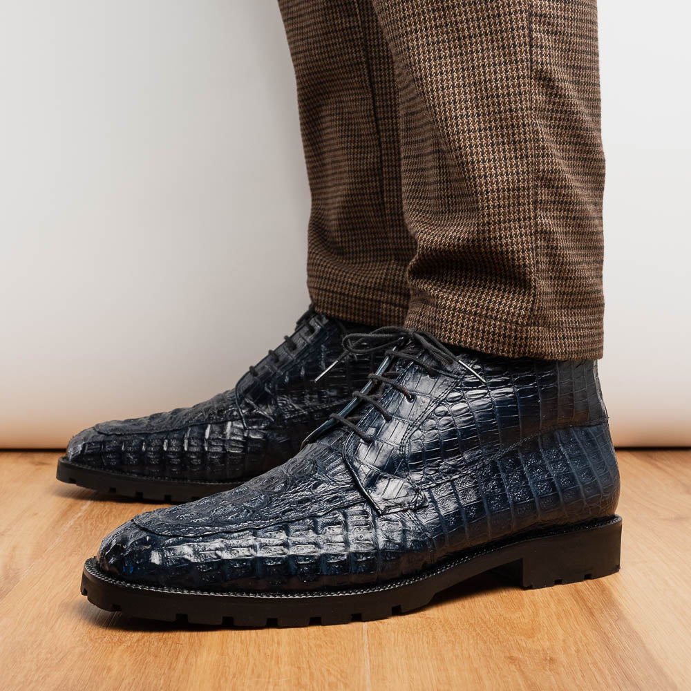 The Martinelli Navy by Marco Di Milano are genuine caiman crocodile boots in dark blue with a lace-up design and rugged black soles—perfect for men who love exotic footwear.