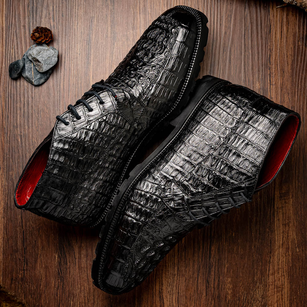 The Marco Di Milano Martinelli Black boots feature crocodile-patterned leather and thick rubber soles—one upright, one sideways to show the tread—for standout men's exotic footwear.