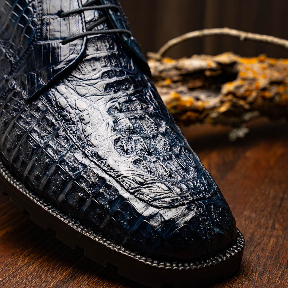The Martinelli Navy by Marco Di Milano are genuine caiman crocodile boots in dark blue with a lace-up design and rugged black soles—perfect for men who love exotic footwear.