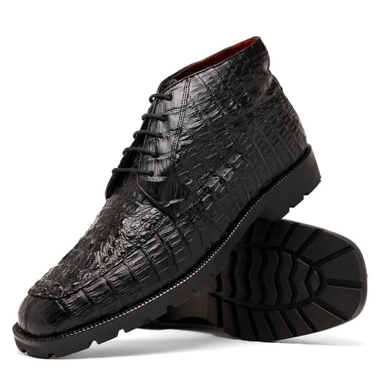 The Marco Di Milano Martinelli Black boots feature crocodile-patterned leather and thick rubber soles—one upright, one sideways to show the tread—for standout men's exotic footwear.