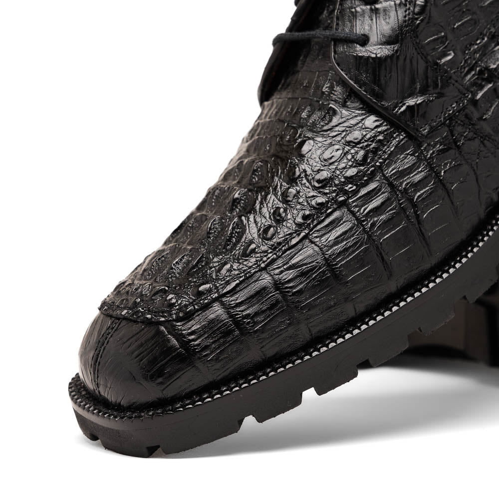 The Marco Di Milano Martinelli Black boots feature crocodile-patterned leather and thick rubber soles—one upright, one sideways to show the tread—for standout men's exotic footwear.