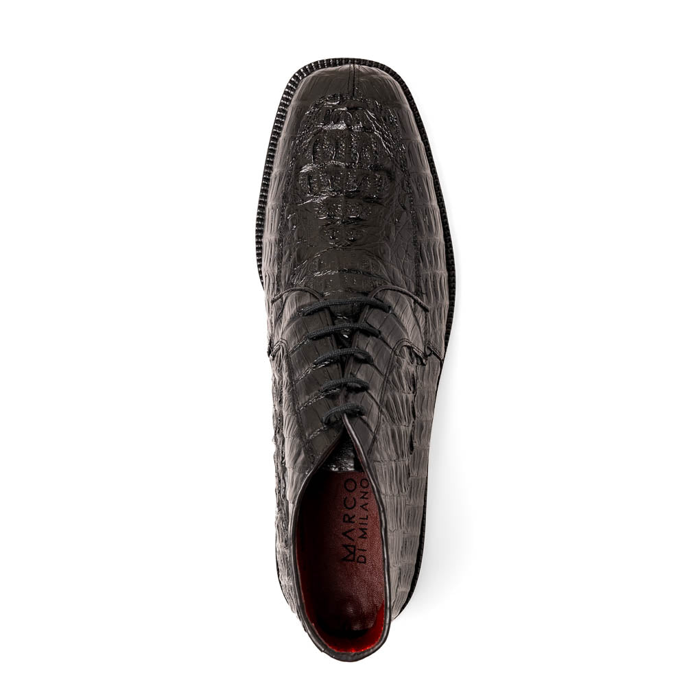 The Marco Di Milano Martinelli Black boots feature crocodile-patterned leather and thick rubber soles—one upright, one sideways to show the tread—for standout men's exotic footwear.