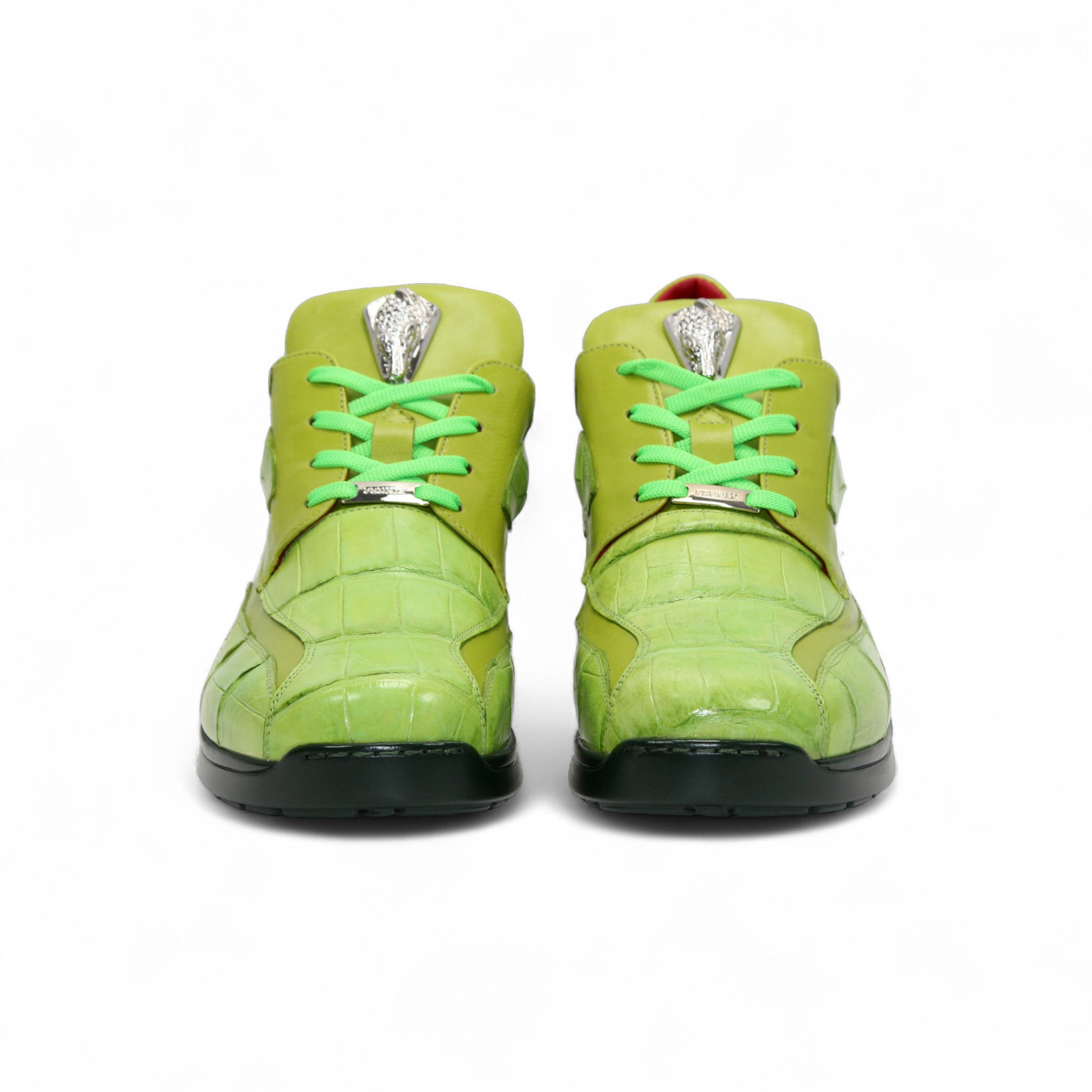 The Fennix Mason Green by Fennix of Italy is a bright green sneaker with a reptile-skin pattern, light green laces, black sole, and a distinctive oval-shaped eyelet detail on the side—an ode to classic Italian alligator shoes.