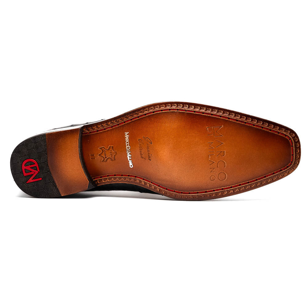The Matteo Black by Marco Di Milano is a pair of black genuine alligator slip-on shoes with a polished brown leather sole, embossed branding, and hand-painted finishes, shown against a white background.