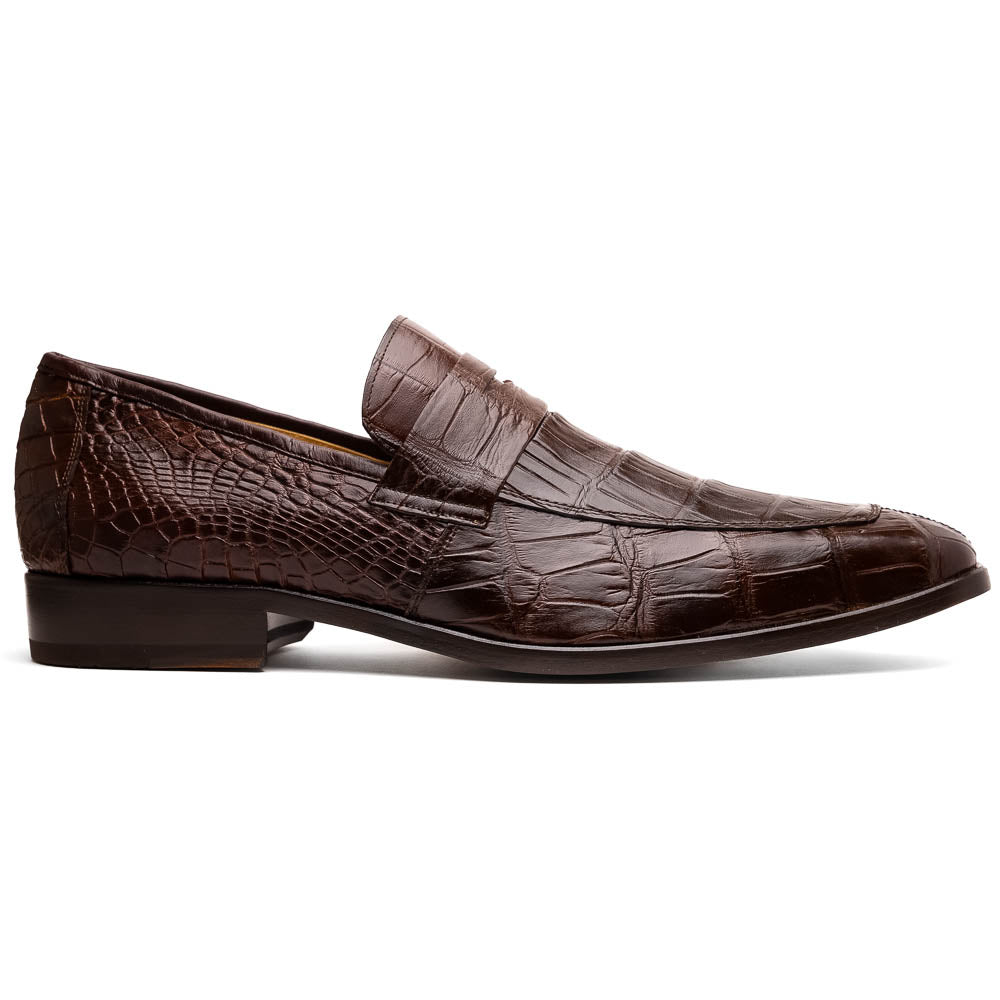 The Matteo Brown by Marco Di Milano is a pair of brown luxury loafers with a crocodile pattern; one shoe lies flat while the other is propped to showcase the sole and elegant hand-painted finishes.