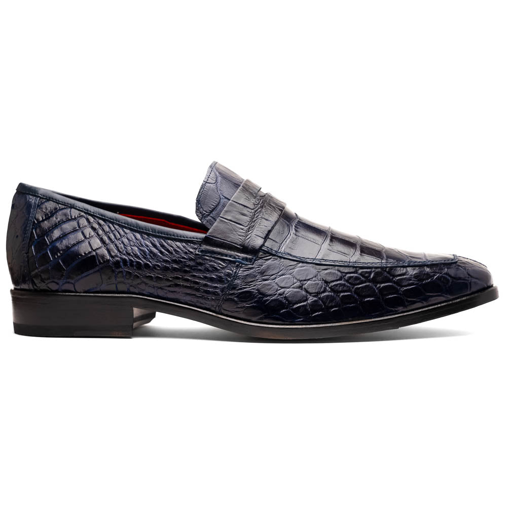 A pair of Matteo Navy loafers by Marco Di Milano, crafted in crocodile-pattern navy leather with a penny strap, red interior lining, and black soles; one shoe props against the other to reveal the sole.