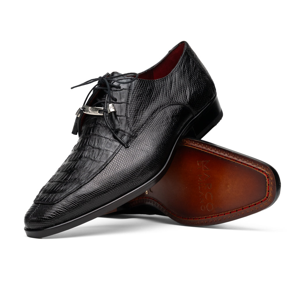 A pair of Merida Black dress derby shoes by Marco Di Milano, crafted from textured black leather caiman—one upright and one on its side revealing the brown sole stamped with the brand’s logo—an unmistakable statement in luxury footwear.
