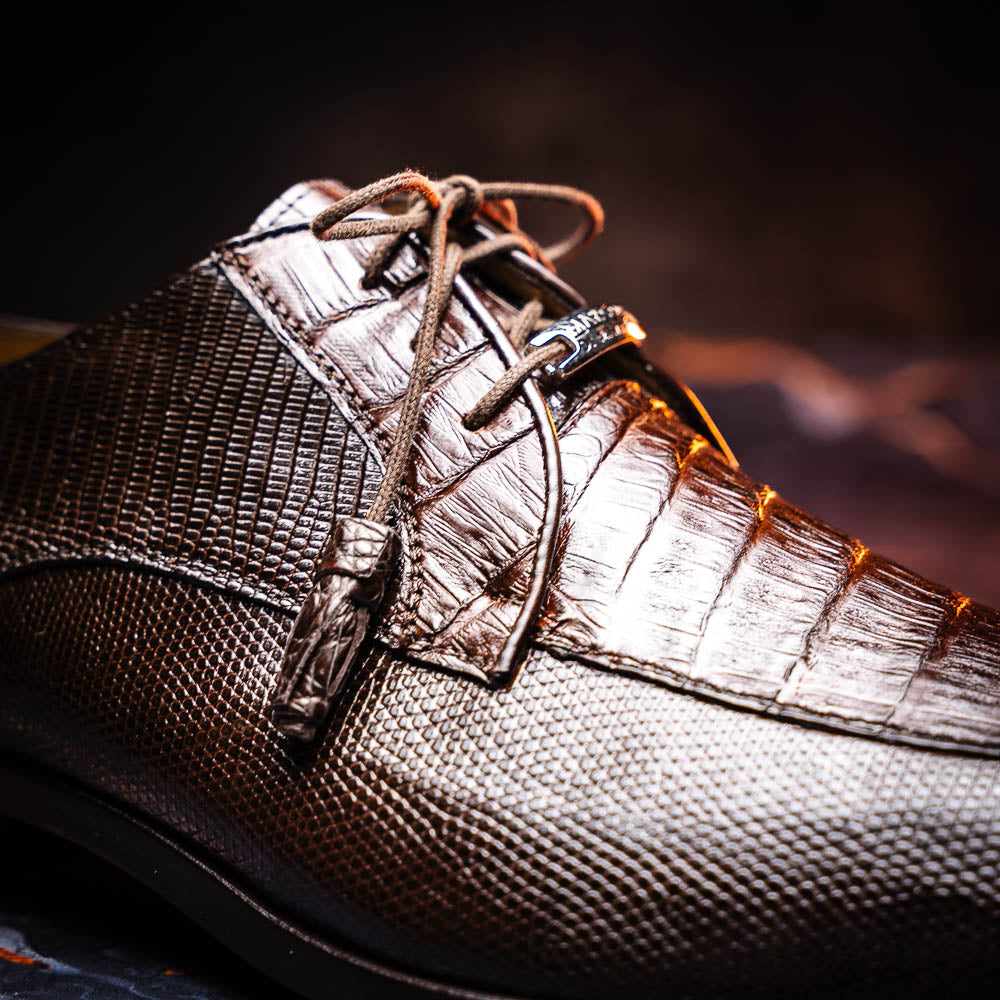 The Merida Brown by Marco Di Milano: a pair of dark brown, textured caiman dress derby shoes with laces—one upright and the other on its side revealing the sole—ideal for those seeking genuine exotic luxury footwear.