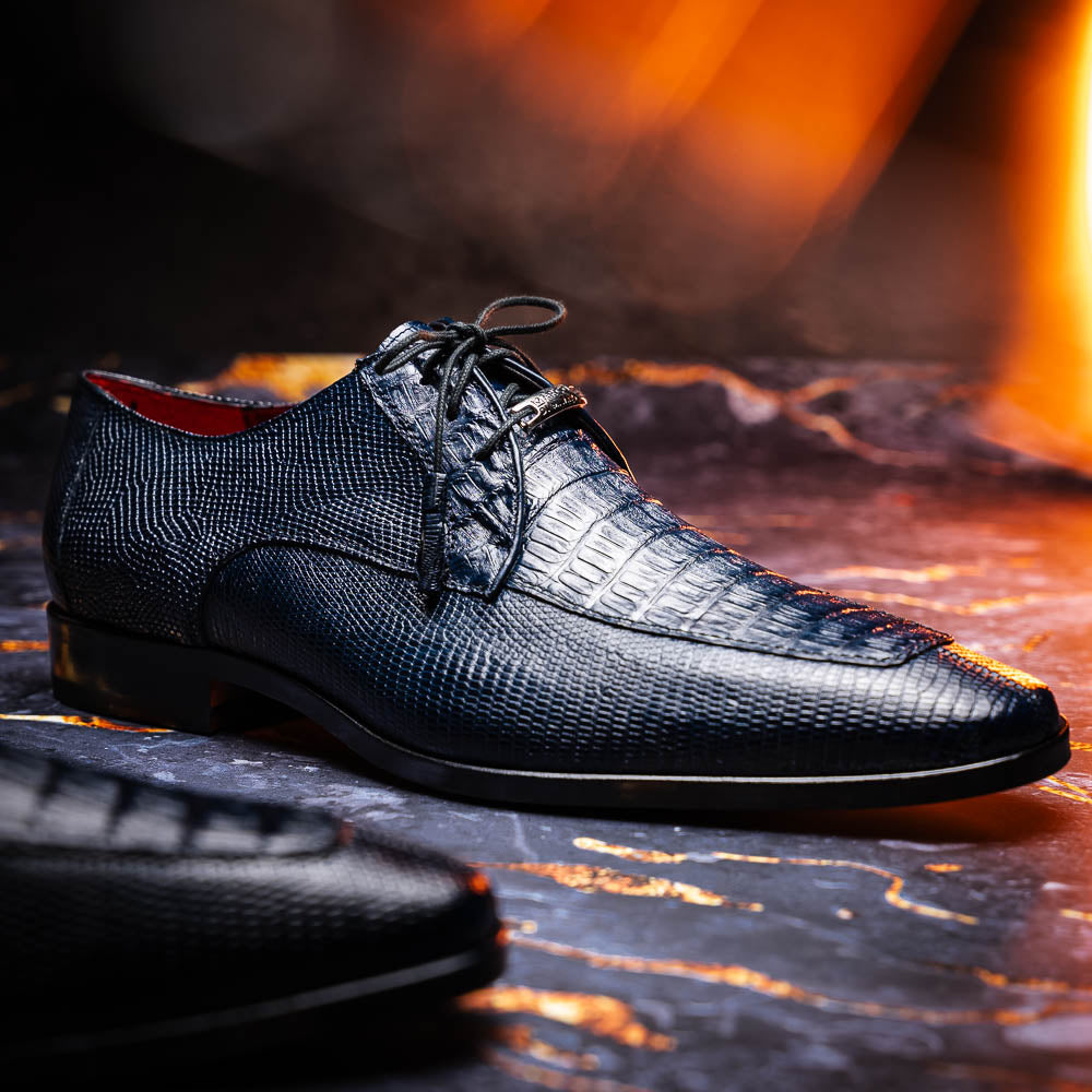 The Merida Navy by Marco Di Milano: blue textured leather caiman dress derby shoes, shown upright and on their side to highlight the sole and striking red inner lining—an elegant expression of luxury footwear.