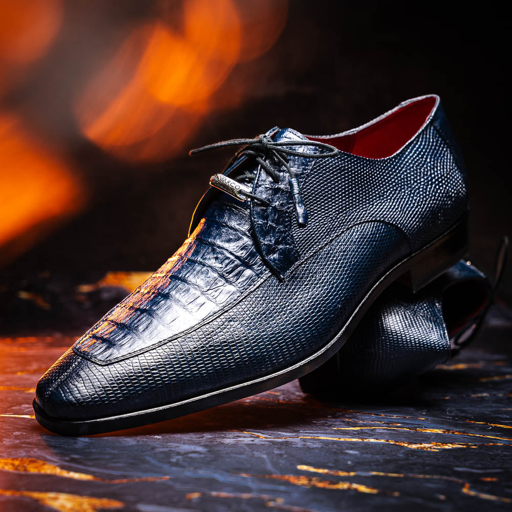 The Merida Navy by Marco Di Milano: blue textured leather caiman dress derby shoes, shown upright and on their side to highlight the sole and striking red inner lining—an elegant expression of luxury footwear.