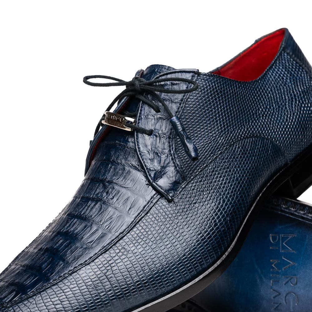 The Merida Navy by Marco Di Milano: blue textured leather caiman dress derby shoes, shown upright and on their side to highlight the sole and striking red inner lining—an elegant expression of luxury footwear.