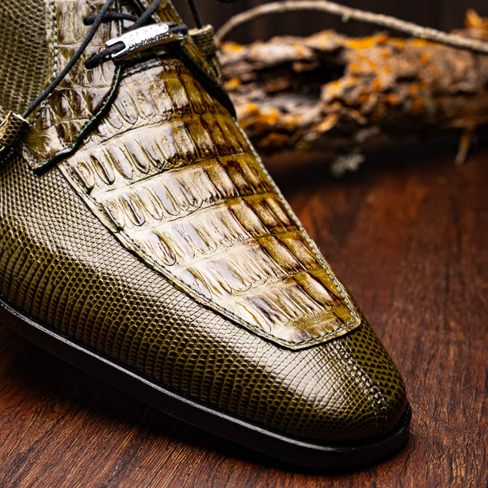 The Merida Olive Green by Marco Di Milano is a pair of olive green textured leather caiman Derby shoes with black laces, red interior lining, dark soles, embossed branding, and hand-painted finishes—a true luxury statement.