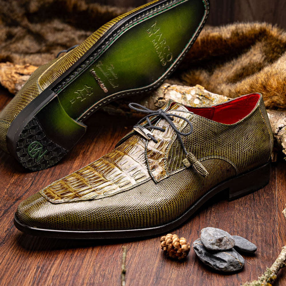 The Merida Olive Green by Marco Di Milano is a pair of olive green textured leather caiman Derby shoes with black laces, red interior lining, dark soles, embossed branding, and hand-painted finishes—a true luxury statement.