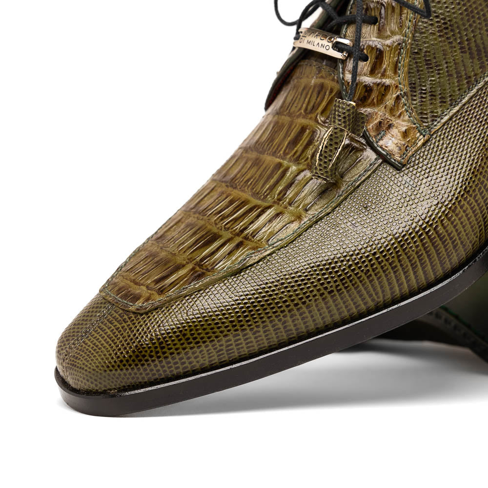 The Merida Olive Green by Marco Di Milano is a pair of olive green textured leather caiman Derby shoes with black laces, red interior lining, dark soles, embossed branding, and hand-painted finishes—a true luxury statement.