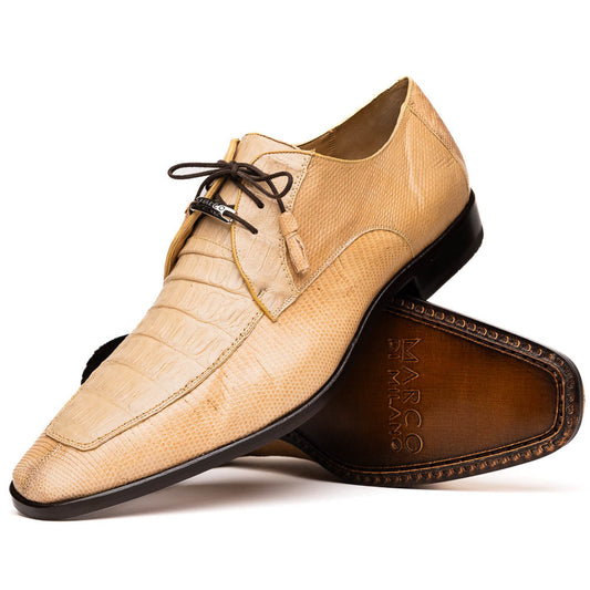 A pair of beige Merida Orix dress derby shoes by Marco Di Milano with black laces, one upright and one leaning to reveal the branded sole—a striking statement in luxury footwear.