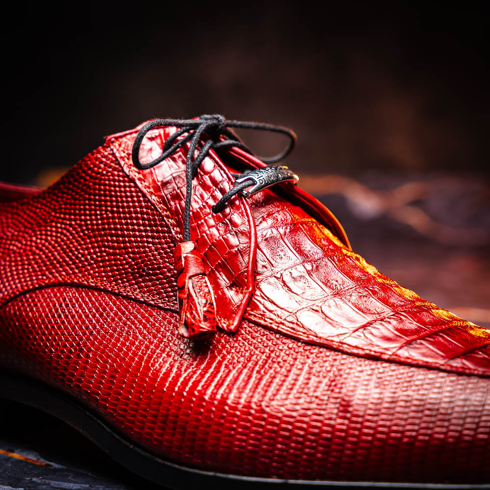 The Merida Red by Marco Di Milano are red textured leather luxury dress shoes with black laces and red tassels, shown both upright and sideways to highlight their hand-painted sole finishes.